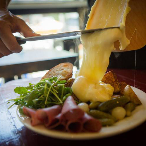 Raclette is a simple dish made of semi-hard cheese on both sides of it